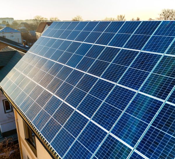 aerial-view-new-modern-two-story-house-cottage-with-blue-shiny-solar-photo-voltaic-panels-system-roof-renewable-ecological-green-energy-production-concept